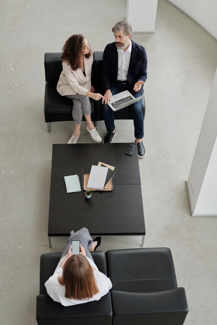 People Sitting on Black Sofa